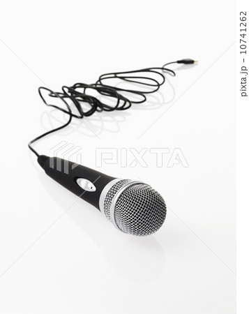 Studio shot of microphone and microphone cable on white background Studio shot of microphone and microphone cable on white background 10741262