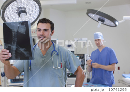Doctor looking at x-ray Doctor looking at x-ray 10741296