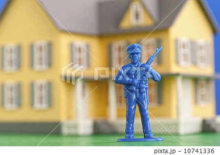 Figurine of soldier in front of model of house 10741336