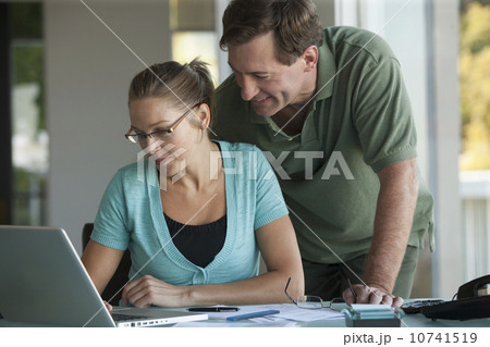 Mature couple working on laptop at home 10741519