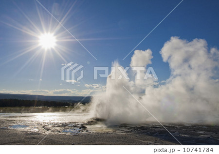 USA, Wyoming, Sun over steaming thermal pool 10741784