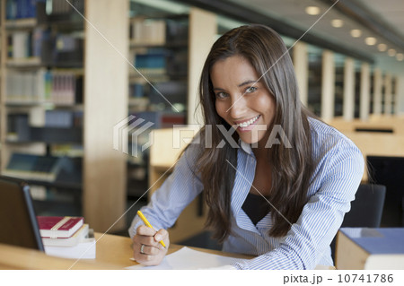Portrait of female student studying in library 10741786