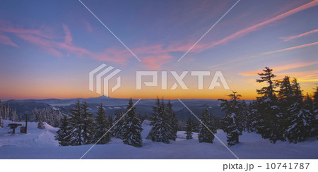 USA, Oregon, Snow covered field with Mount Jefferson in background, sunset 10741787