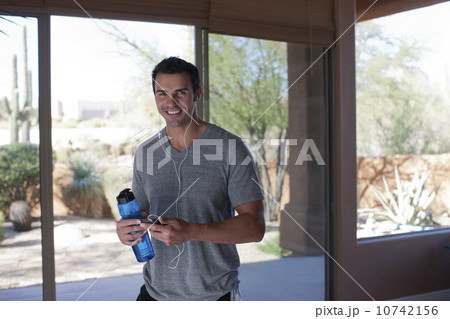 Portrait of man holding water bottle 10742156