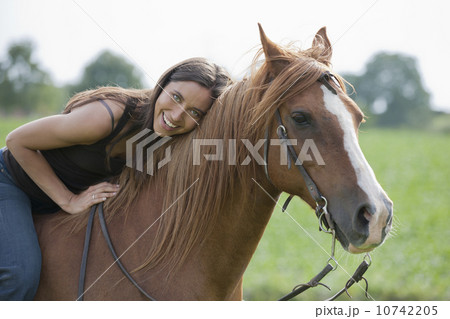 Portrait of young woman riding horse 10742205