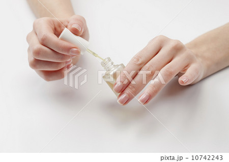 Close up of woman's hands holding nail polish, studio shot 10742243