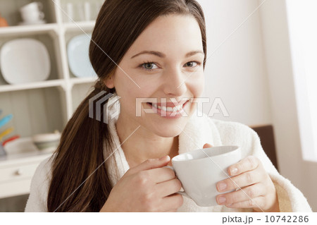Young smiling woman holding cup 10742286