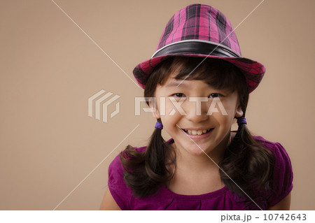 Studio portrait of girl (10-11) wearing hat 10742643