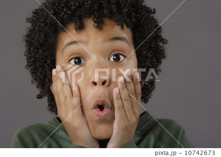 Portrait of surprised boy (8-9), studio shot 10742673