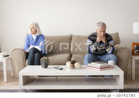 Angry senior couple sitting on sofa 10742783