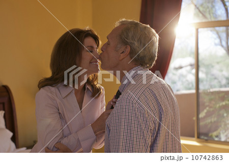 Woman helping man get dressed 10742863