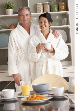Couple in bathrobes with coffee cups 10742951