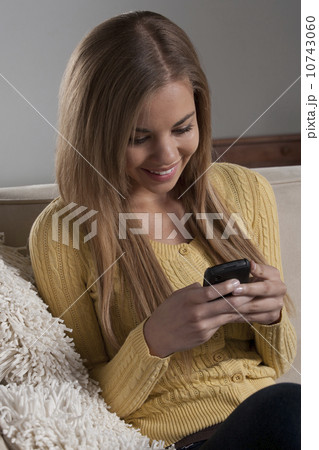 Portrait of teenage girl (16-17) with mobile phone Portrait of teenage girl (16-17) with mobile phone 10743060