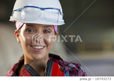 Portrait of female manual worker wearing hardhat 10743273
