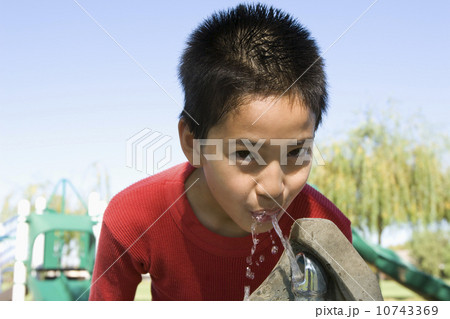 Boy (12-13) at drinking fountain 10743369