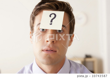 Portrait of businessman with adhesive note attached on forehead 10743587