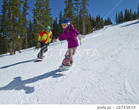 USA, Colorado, Telluride, Father and daughter (10-11) snowboarding  10743639