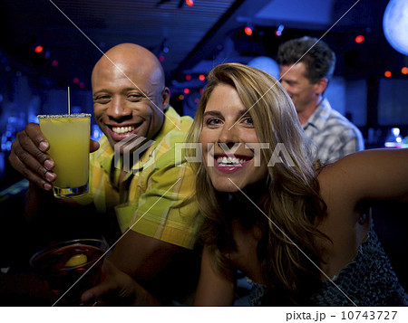 Friends enjoying drinks at bar Friends enjoying drinks at bar 10743727