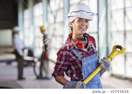 Portrait of female manual worker wearing hardhat 10743838