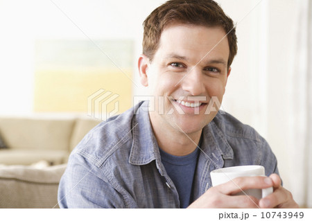 Portrait of smiling mid adult man holding mug Portrait of smiling mid adult man holding mug 10743949