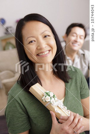 Woman receiving gift from man 10744043