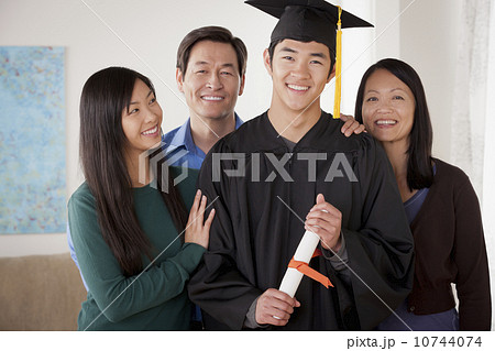 Portrait of young man in graduation gown with family 10744074