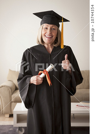Senior woman wearing graduation gown Senior woman wearing graduation gown 10744354