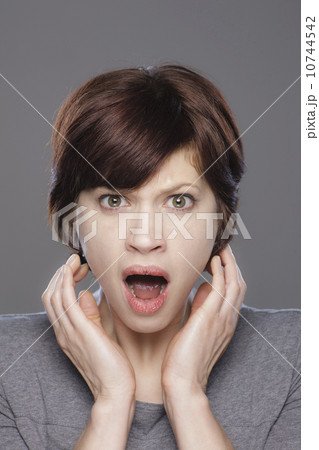 Studio shot of shocked young woman 10744542