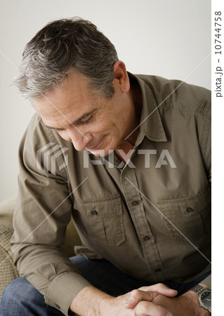 Worried mature man sitting on sofa 10744758