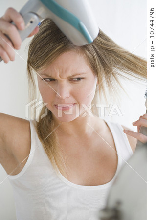 Woman drying hair Woman drying hair 10744796