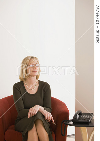 Businesswoman sitting in armchair 10744797