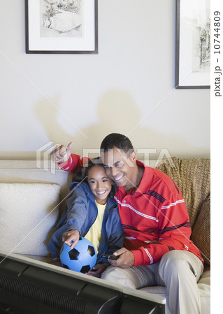 Father and Daughter (10-11) watching tv Father and Daughter (10-11) watching tv 10744809