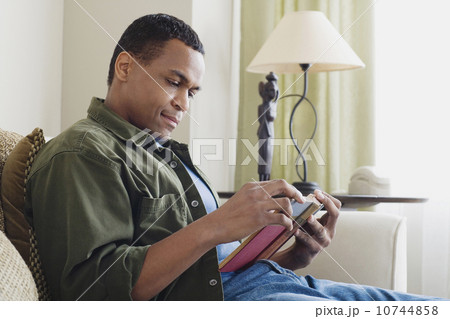 Man reading book at home 10744858