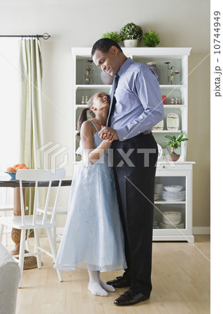 Father and Daughter (10-11) dancing in kitchen 10744949