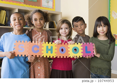 Portrait of schoolchildren (6-7) holding colorful letters Portrait of schoolchildren (6-7) holding colorful letters 10744953
