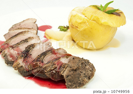roast goose breast with apple sauce on white plate 10749956