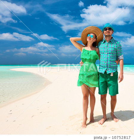 Couple in green on a beach at Maldives 10752817