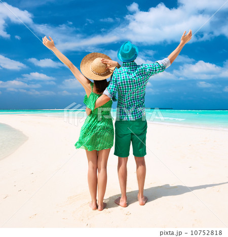 Couple in green on a beach at Maldives 10752818