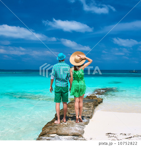 Couple in green on a beach at Maldives Couple in green on a beach at Maldives 10752822