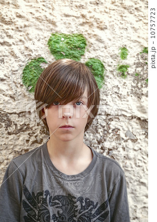 portrait of a teenager boy with green shamrock behind his head 10757723