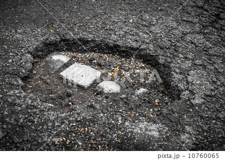 Tarmac road with big holes Tarmac road with big holes 10760065