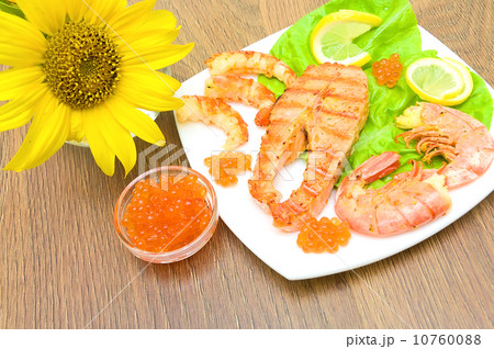 Salmon grilled steak, grilled shrimp and red caviar on a wooden Salmon grilled steak, grilled shrimp and red caviar on a wooden 10760088