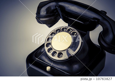 Old black phone with dust and scratches on white background Old black phone with dust and scratches on white background 10763827