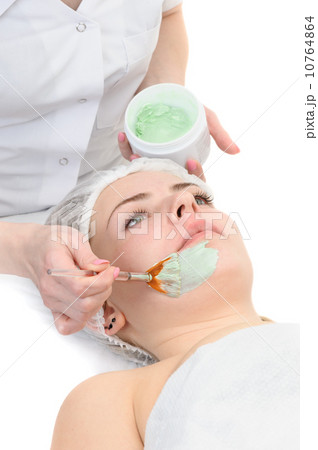 beauty salon, facial mask applying using brush 10764864