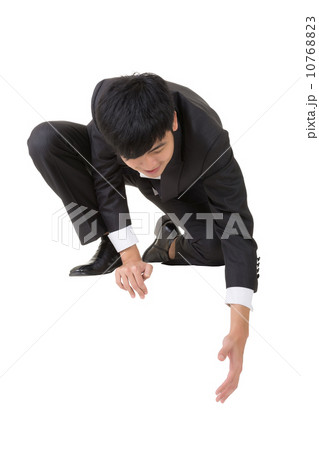 Asian businessman sit and bend down to help somebody 10768823