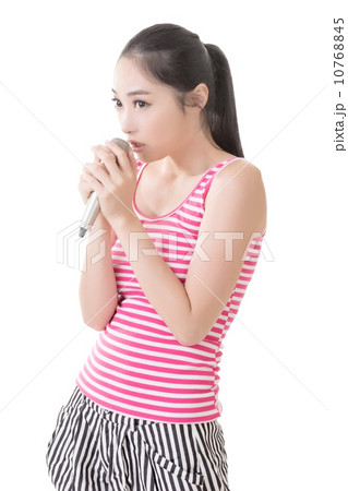Asian girl take a microphone singing or speak Asian girl take a microphone singing or speak 10768845