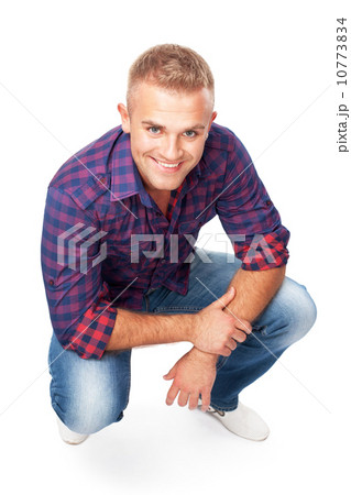 Portrait of smiling young man squatting 10773834