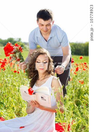 Young happy couple on a meadow full of poppies 10778923