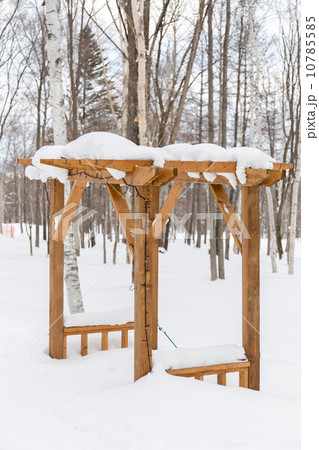 wooden kiosk covered by snow 10785585
