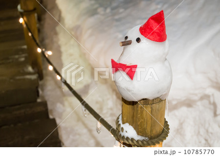 snowman against winter night scene in snow 10785770
